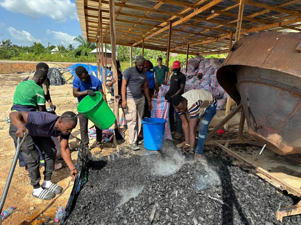 Workers prepare biochar to be delivered to farmers.